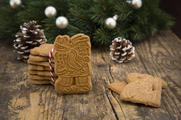Almond biscuits, fir cones and decorated fir branch on wood  LVF002443