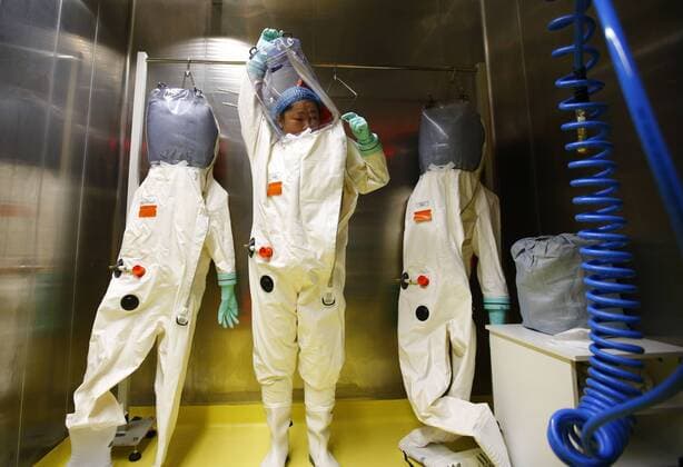 (150131) -- WUHAN, A researcher puts on a protective suit before entering the newly-completed lab in Wuhan, capital of central China s Hubei Province, Jan. 30, 2015. China completed its first high level biosafety laboratory based in Wuhan Saturday in Wuhan after more than a decade of construction. The lab will be used to study class four pathogens (P4), which refers to the most virulent viruses that pose a high risk of aerosol-transmitted person-to-person infections. ) (wyo) CHINA-WUHAN-BIOSAFETY LAB (CN) YinxGang 