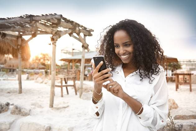 Happy young woman outdoors with cell phone model released Symbolfoto property released  KD000406