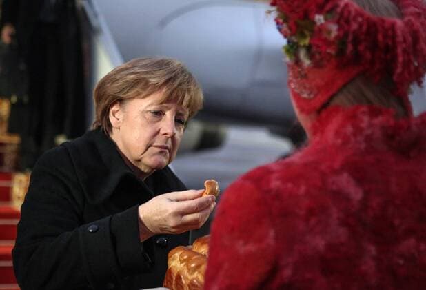 MINSK, BELARUS. FEBRUARY 11, 2015. Germany s chancellor Angela Merkel welcomed at a city s airport. Merkel has arrived in Minsk to attend Normandy format Ukraine peace talks. Andrei Pokumeiko BelTA TASS  RE15B9F4