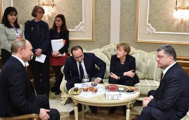 MINSK, BELARUS. FEBRUARY 11, 2015. Russia s president Vladimir Putin, France s president Francois Hollande, Germany s chancellor Angela Merkel and Ukraine s president Petro Poroshenko (L-R seated) seen during Normandy format Ukraine peace talks at the Palace of Independence in Minsk. Mykola Lazarenko Ukrainian presidential press service TASS  RE15BA09