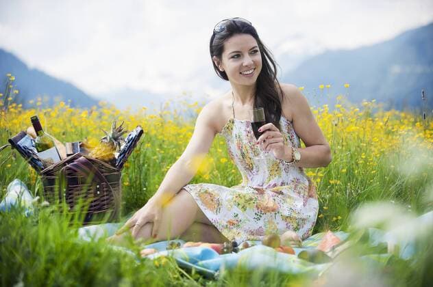 Young woman having picnic on alpine meadow model released Symbolfoto  HHF005050