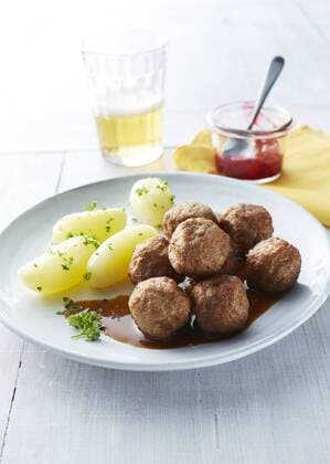 Koettbullar, Swedish meatballs with potatoes and sauce on plate, cowberries  KSWF001353
