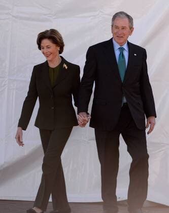 President George W. Bush and his wife Laura walk to their seats before President Barack Obama addressed a crowd gathered at the foot of the historic Edmund Pettus Bridge to commemorate the violence 50 years ago during the March on Selma, in Selma, Alabama, March 7, 2015.  AJP2015030719 DAVIDxTULIS