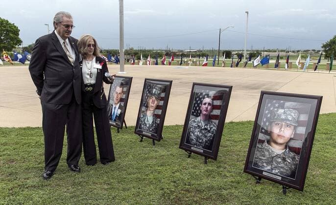 April 10, 2015 - Fort Hood, Texas, U.S - Jeffrey and Sheryll Pearson, parents of Pfc. Michael Pearson, second picture from right, who was killed during the attack by Maj. Nidal Hasan in the 2009 Fort Hood shooting, visit in front of his picture prior to a Purple Heart ceremony held at Fort Hood, Texas, Friday, April 10, 2015. Survivors and family members of those killed during the attack were awarded medals: a Purple Heart for soldiers and Defense of Freedom Medals for civilians. Fort Hood U.S. - ZUMAp124