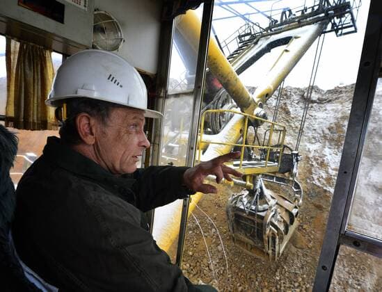 SAKHA, RUSSIA. APRIL 20, 2015. An excavator driver loading gold ore into a truck on the grounds of the Kuranakh gold field owned by AldanZoloto Mining Company. AldanZoloto is a subsidiary of Polyus Gold. Yuri Smityuk TASS  TS000939