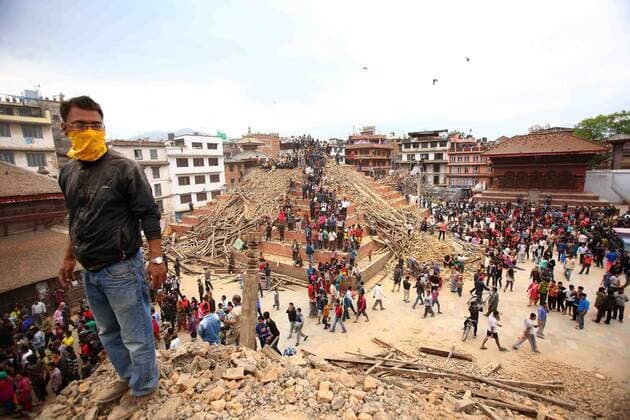Rescue workers inspect the rubble of a building for possible survivors in Kathmandu, Nepal, on April 25 2015. New tremors sent shocked survivors scurrying outdoors just 24 hours after a devastating 7.9 magnitude earthquake shook the region which so far has taken the lives of at least 2,500 people.  NEP2015042601 SanjogxManandhar