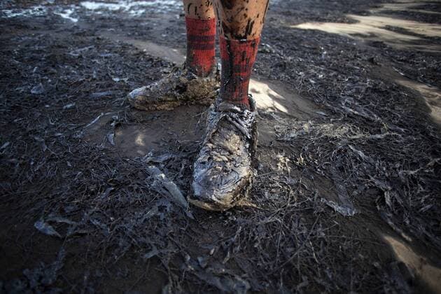 May 19, 2015 - Goleta, California, U.S - JAKE LEE shows off his shoes covered in oil as he walks the shoreline of Refugio State Beach taking photos of an oil spill Tuesday afternoon. An estimated 21,000 gallons of crude oil dumped into the ocean from a broken pipeline. Goleta U.S. - ZUMAh129