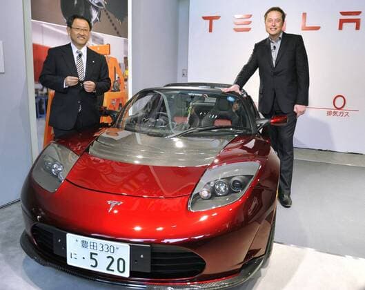 TOKYO, Japan - Tesla Motors Inc. Chief Executive Officer Elon Musk (R) presents Toyota Motor Corp. President Akio Toyoda (L) with its new Roadster 2.5 EV in Tokyo on Nov. 12, 2010. The move marks a partnership between the U.S. electric vehicle maker and the top Japanese automaker.  1112064