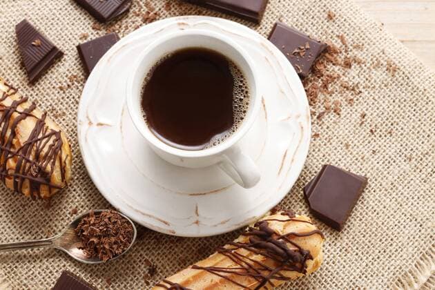 Cup of coffee and eclairs. Party dessert  Copyright: KantarukxAgnieszka bew19D9B2F