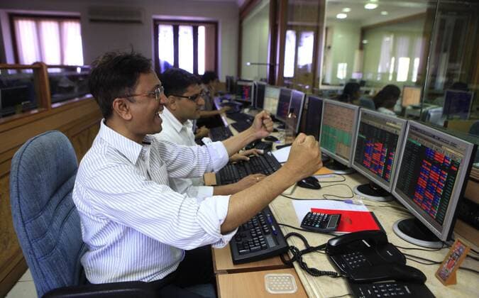 MUMBAI, INDIA - MAY 13: Stock traders rejoice the as Sensex rose to a third consecutive record high at Bombay stock exchange on May 13, 2014 in Mumbai, India. The Sensex hit a record high of 24,068.94, surpassing the psychologically important 24,000 mark for the first time in its history surging after exit polls showed the Bharatiya Janata Party and its allies winning a majority in the elections. (Photo by Anshuman Poyrekar Hindustan Times ) BSE Sensex Hits Life High Above 24,000 After Exit Polls