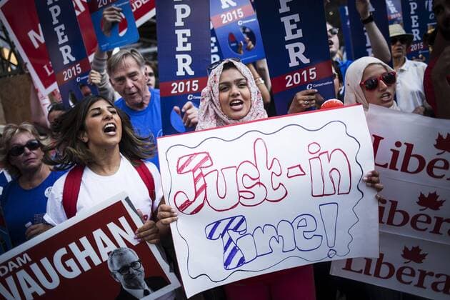 Aug. 6, 2015 - Toronto, ON, Canada - TORONTO, ON- August 6 - Alisha Adat (left), 23, and Tanvir Janmohamed (centre), 22, have been volunteering for Liberal party for the past four years. They show their support for Justin Trudeau on Victoria Street before the federal party leaders face off in the first election debate. August 6, 2015 Toronto Canada  - ZUMAt14_