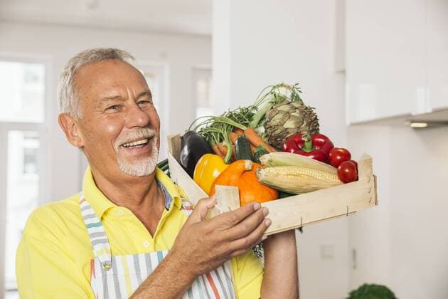 Portrait of man holding wooden box of vegetables model released Symbolfoto property released  MFF001755