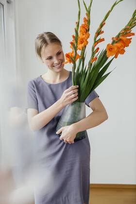 Woman holding a large vase with Gladiola model released Symbolfoto property released  MFF001855