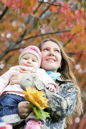 junge Mutter mit ihrer Tochter an einem schoenen Herbsttag im Freien Young mother with daughter enjoying beautiful autumn day BLWS237842