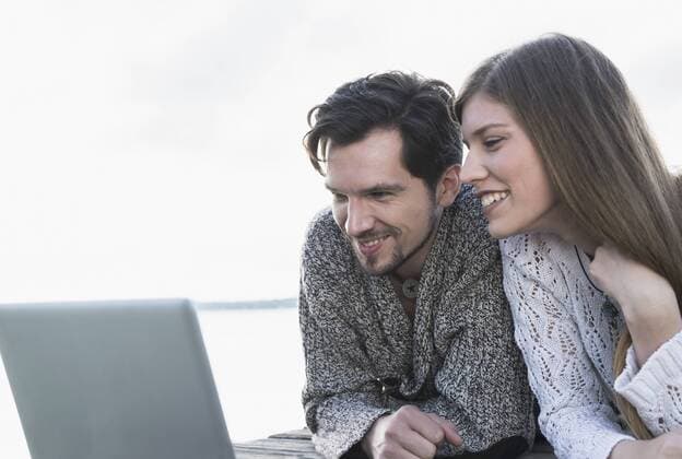 Young couple working laptop computer outdoors mit_2002_06271