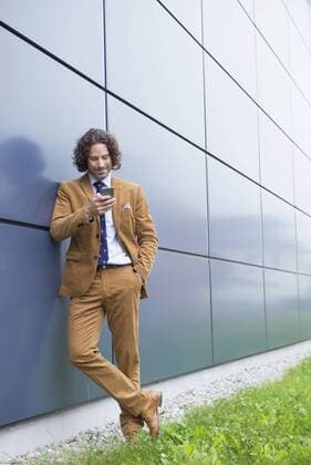 Portrait man business suit cell phone reading SMS mit_2002_06284