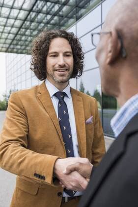 Close up portrait men shaking hands multiracial mit_2002_06333