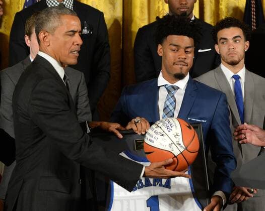 U.S. President Barack Obama looks at a Duke team basketball he was given during a celebration event in the East Room of the White House in Washington, DC on September 8, 2015. The Duke Blue Devils won the NCAA college basketball championship in March of 2015.  WAP2015090809 PATxBENIC
