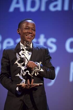 (150912) -- VENICE, Sept. 12, 2015 -- Actor Abraham Attah poses with the Marcello Mastroianni Award to a Young Actor for his role in Beasts of No Nations , during the award ceremony at the 72nd Venice Film Festival, at the Lido of Venice, Italy, Sept. 12, 2015. ) ITALY-VENICE-FILM-FESTIVAL-72ND-AWARD JinxYu 