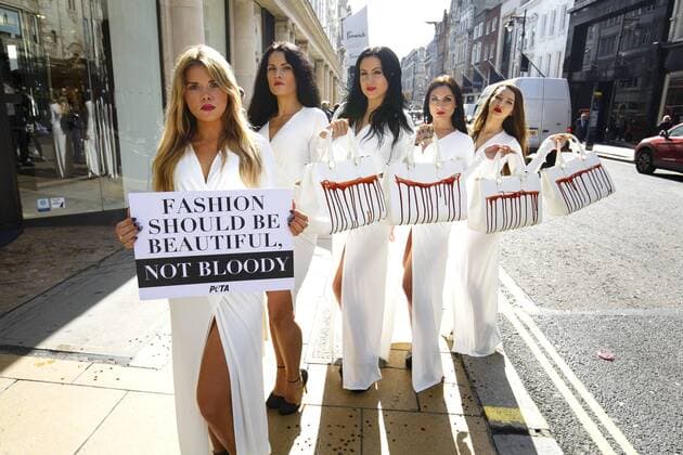 Sept. 17, 2015 - London, London, UK - London, UK. PETA models holding brandishing handbags covered in fake blood to protest against the use of animal skins in London Fashion Week on Thursday, 17 September 2015 in central London. London UK  - ZUMAl94_