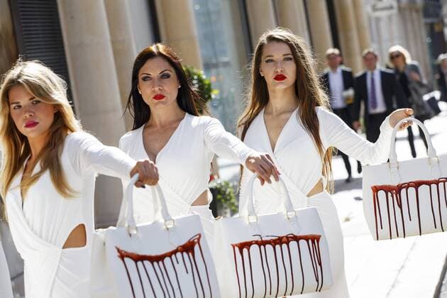 Sept. 17, 2015 - London, London, UK - London, UK. PETA models holding brandishing handbags covered in fake blood to protest against the use of animal skins in London Fashion Week on Thursday, 17 September 2015 in central London. London UK  - ZUMAl94_