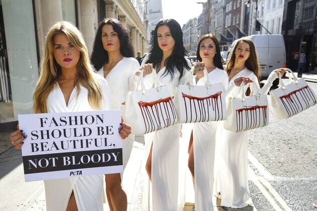 Sept. 17, 2015 - London, London, UK - London, UK. PETA models holding brandishing handbags covered in fake blood to protest against the use of animal skins in London Fashion Week on Thursday, 17 September 2015 in central London. London UK  - ZUMAl94_
