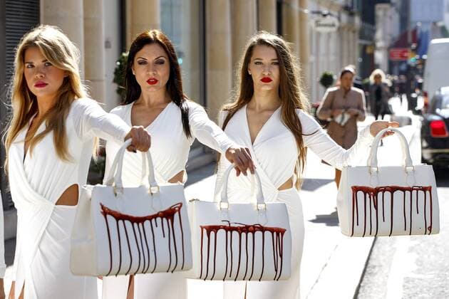 Sept. 17, 2015 - London, London, UK - London, UK. PETA models holding brandishing handbags covered in fake blood to protest against the use of animal skins in London Fashion Week on Thursday, 17 September 2015 in central London. London UK  - ZUMAl94_