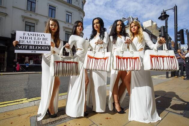Sept. 17, 2015 - London, London, UK - London, UK. PETA models holding brandishing handbags covered in fake blood to protest against the use of animal skins in London Fashion Week on Thursday, 17 September 2015 in central London. London UK  - ZUMAl94_