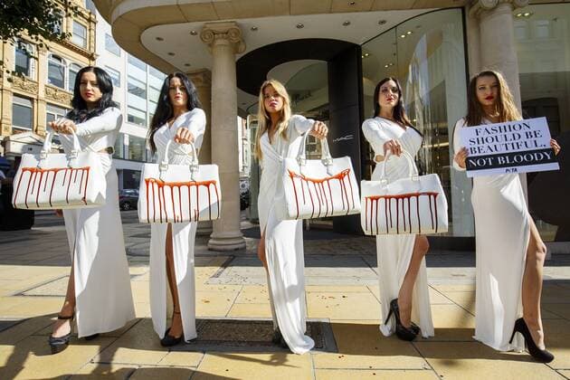 Sept. 17, 2015 - London, London, UK - London, UK. PETA models holding brandishing handbags covered in fake blood to protest against the use of animal skins in London Fashion Week on Thursday, 17 September 2015 in central London. London UK  - ZUMAl94_