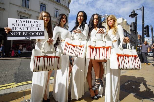 Sept. 17, 2015 - London, London, UK - London, UK. PETA models holding brandishing handbags covered in fake blood to protest against the use of animal skins in London Fashion Week on Thursday, 17 September 2015 in central London. London UK  - ZUMAl94_