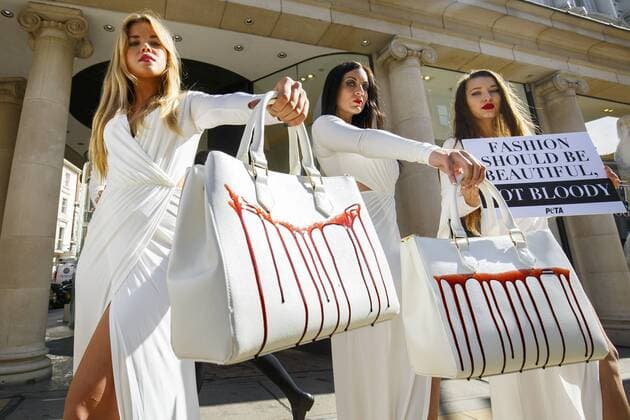 Sept. 17, 2015 - London, London, UK - London, UK. PETA models holding brandishing handbags covered in fake blood to protest against the use of animal skins in London Fashion Week on Thursday, 17 September 2015 in central London. London UK  - ZUMAl94_