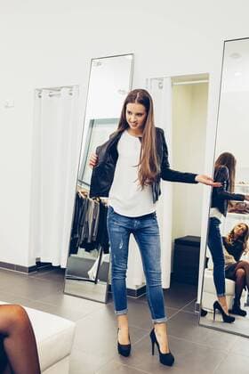 Young woman presenting new clothes in a boutique model released Symbolfoto property released  CHAF001329