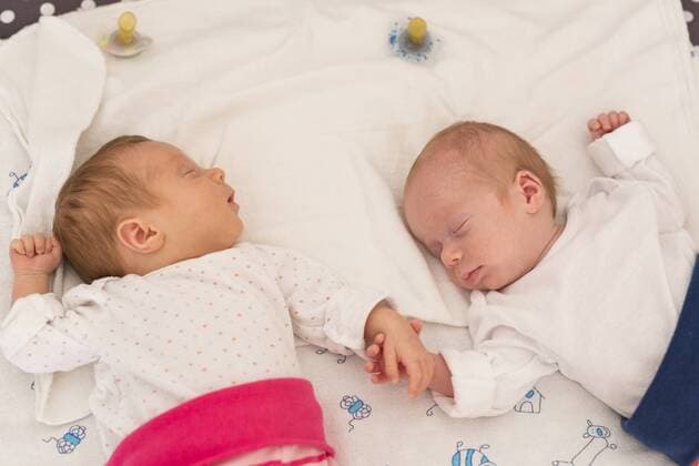 Newborn twins sleeping hand in hand model released Symbolfoto  SHKF000348