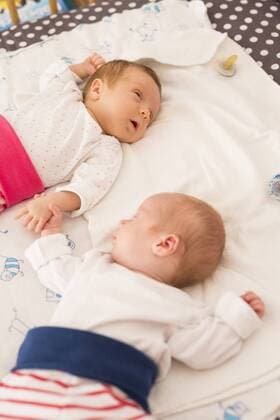 Newborn twins sleeping hand in hand model released Symbolfoto  SHKF000350