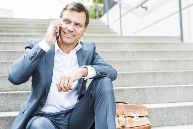 Businessman sitting on stairs using smart phone model released Symbolfoto  UUF005225