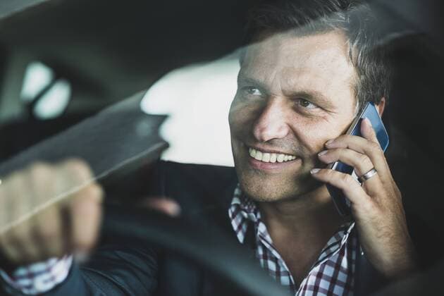 Mature businessman using smart phone in the car model released Symbolfoto  UUF005254