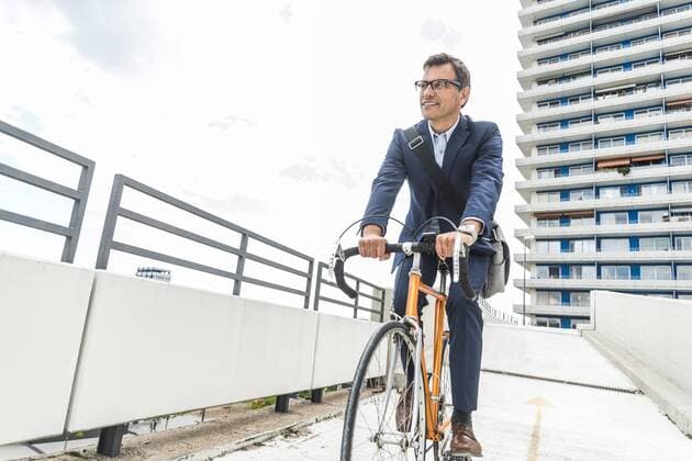 Businessman riding bicycle model released Symbolfoto  UUF005336