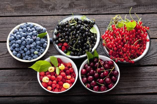 Bowls of sour cherries, raspberries, red and black currants and blueberries  CSF026131