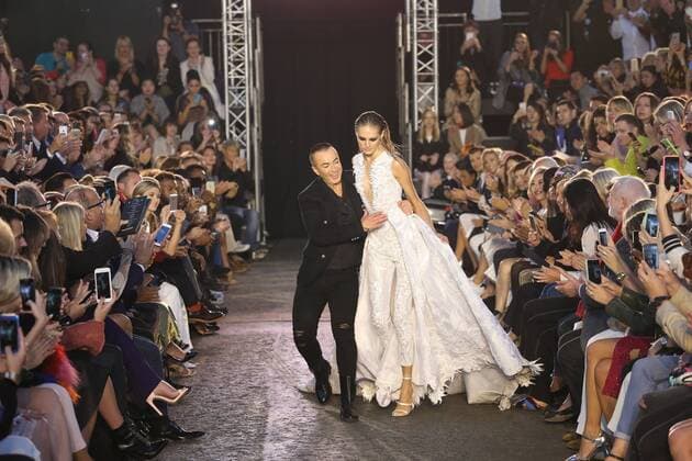. 19 09 2015. London, United Kingdom. Designer Julien Macdonald helps a model who trips at the finale of his show at London Fashion Week-S S 2016-Day two.  xStephenxLockx xi-Imagesx IIM-11062-0039
