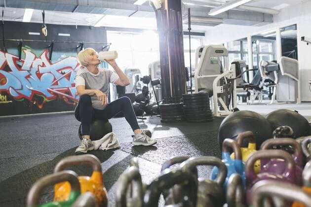 Senior woman in gym having a break model released Symbolfoto property released  MADF000508