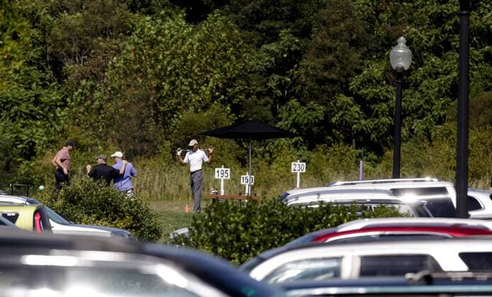 US President Barack Obama stretches before playing golf at Renditions Golf Club in Davidsonville, Md, on September 19, 2015. Pool photo by Aude Guerrucci  WAX20150919903