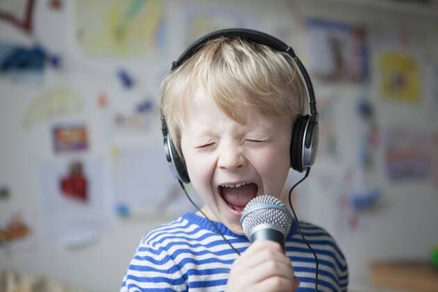 Portrait of singing little boy with headphones and microphone model released Symbolfoto property released  RBF002990