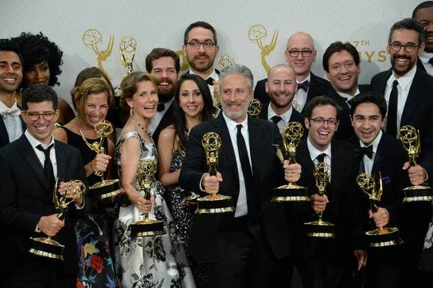 Jon Stewart (C) and the writers of The Daily Show with Jon Stewart , winners of Outstanding Variety Talk Series and Outstanding Writing for a Variety Series pose in the photo room at the 67th Primetime Emmy Awards in the Microsoft Theater in Los Angeles on September 20, 2015.  LAP2015092214 JIMxRUYMEN
