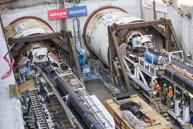 Sept. 24, 2015 - Toronto, ON, Canada - TORONTO, ON - SEPTEMBER 24 - Workers are dwarfed standing beside two large boring machines on Eglinton Ave. East, where they will soon begin boring toward Yonge St. The Crosstown is a light rail transit (LRT) line that will run across Eglinton Avenue between Mount Dennis (Weston Road) and Kennedy Station. This 19-kilometre corridor will include a 10-kilometre underground portion, between Keele Street and Laird Drive. September 24, 2015. Toronto Canada  - ZUMAt14_