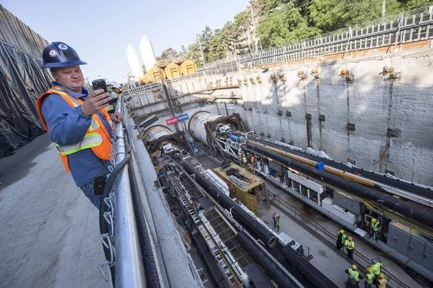 Sept. 24, 2015 - Toronto, ON, Canada - TORONTO, ON - SEPTEMBER 24 - Chris Dehaas, a rescue trainer, takes a picture of two large boring machines on Eglinton Ave. East, where they will soon begin boring toward Yonge St. The Crosstown is a light rail transit (LRT) line that will run across Eglinton Avenue between Mount Dennis (Weston Road) and Kennedy Station. This 19-kilometre corridor will include a 10-kilometre underground portion, between Keele Street and Laird Drive. September 24, 2015. Toronto Canada  - ZUMAt14_