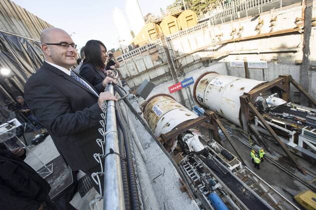 Sept. 24, 2015 - Toronto, ON, Canada - TORONTO, ON - SEPTEMBER 24 - Transportation Minister Steven Del Duca and Mitzie Hunter, Associate Minister of Finance and MPP for Scarborough-Guildwood, look at two large boring machines on Eglinton Ave. East, where they will soon begin boring toward Yonge St. The Crosstown is a light rail transit (LRT) line that will run across Eglinton Avenue between Mount Dennis (Weston Road) and Kennedy Station. This 19-kilometre corridor will include a 10-kilometre underground portion, between Keele Street and Laird Drive. September 24, 2015. Toronto Canada  - ZUMAt14_