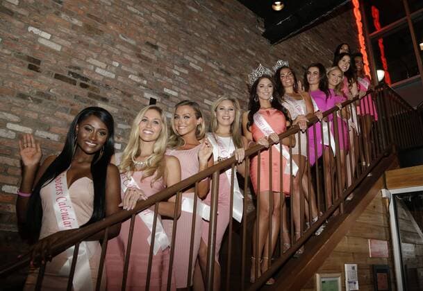 The 2016 Hooters Calendar Girls stand on a staircase before signing calendars for customers and fans at Hooters Restaurant in New York City on October 1, 2015. The 2016 Hooters Calendar Girls were selected from over 25,000 Hooters girls worldwide.  NYP20151001104 JOHNxANGELILLO