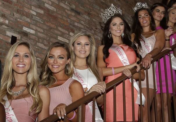 2016 Hooters Calendar cover girl Meagan Pastorchik stands with Brittany Pierce and other calendar girls before signing calendars and greeting customers at Hooters Restaurant in New York City on October 1, 2015. The 2016 Hooters Calendar Girls were selected from over 25,000 Hooters girls worldwide.  NYP20151001114 JOHNxANGELILLO