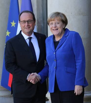 German Chancellor Angela Merkel is greeted by French President Francois Hollande at the Elysee Palace in Paris on October 2, 2015. Merkel and Hollande will meet with Russian President Vladimir Putin and Ukrainian President Petro Poroshenko to discuss a lasting political solution in Ukraine, in accordance with the Minsk accords established by these four leaders earlier this year.  PAR20151002726 DAVIDxSILPA